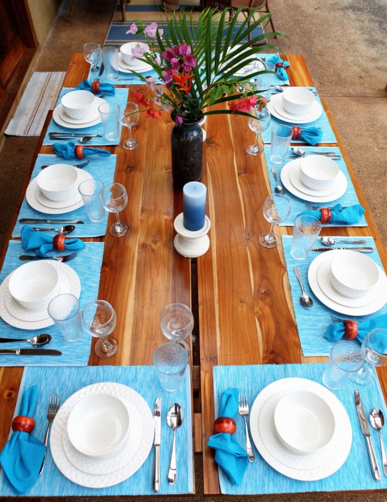 The teak table set for ten, seen from above at Casa Colorado, a vacation rental home with a private pool in Tamarindo, Costa Rica