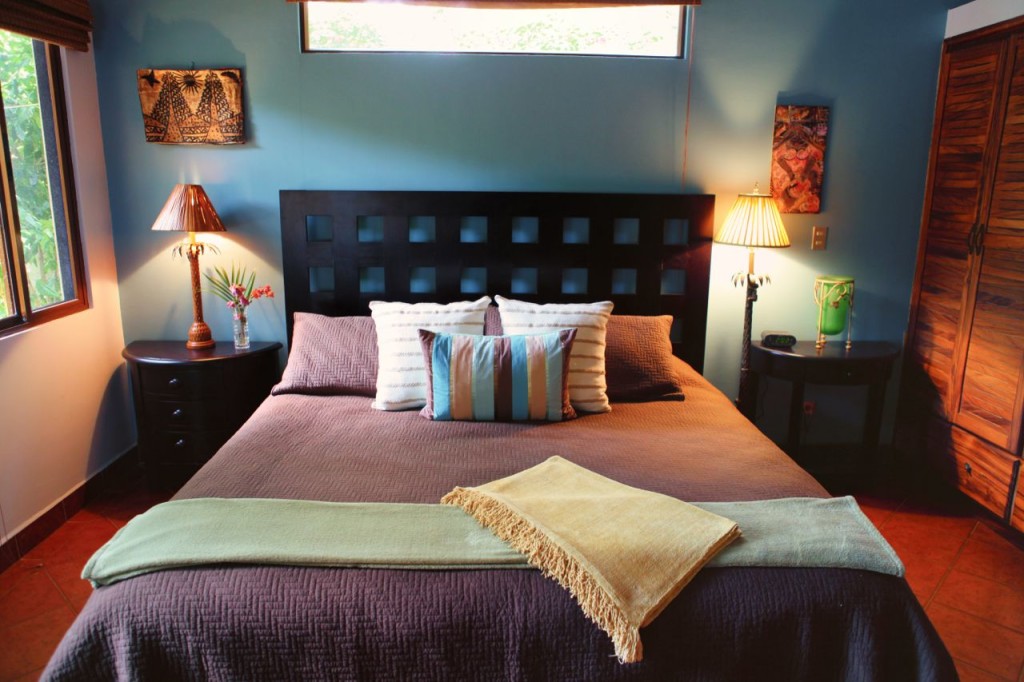 The king bed in the master suite at Casa Colorado, a vacation rental home with a private pool in Tamarindo, Costa Rica