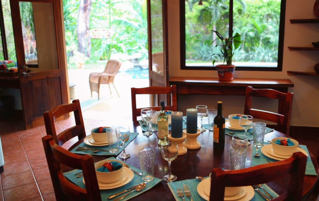 The dining table by the garden windows at Casa Colorado, a vacation rental home with a private pool in Tamarindo, Costa Rica