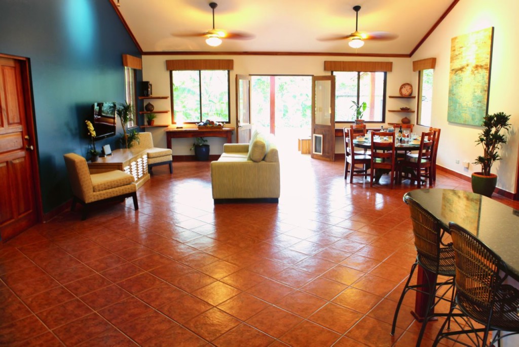 Ceiling fans and tile floors across the open great room at Casa Colorado, a vacation rental home with a private pool in Tamarindo, Costa Rica