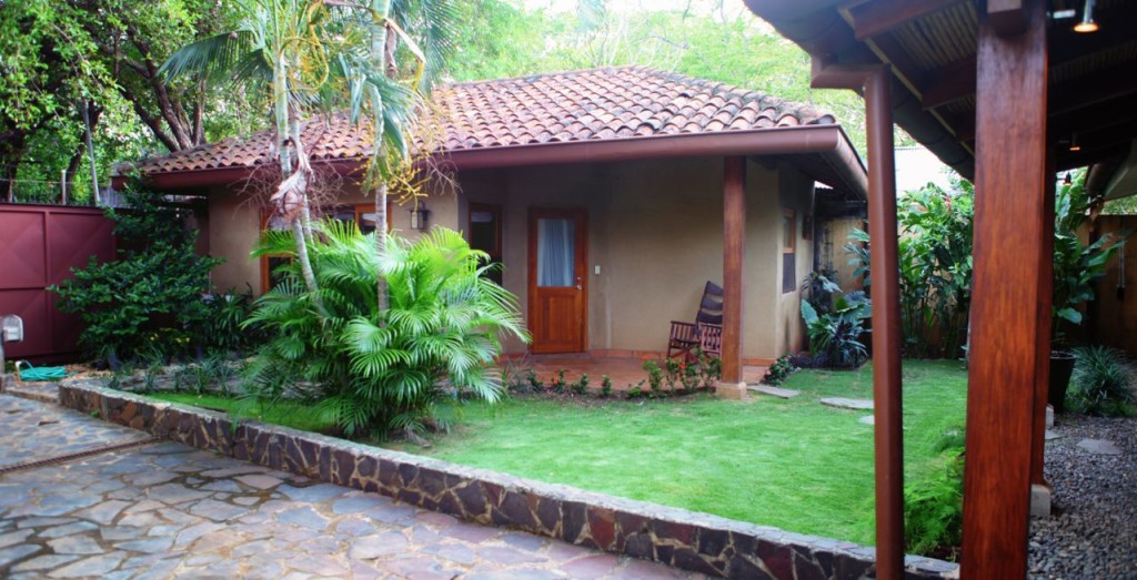 The courtyard lawn and casita in daylight at Casa Colorado, a vacation rental home with a private pool in Tamarindo, Costa Rica