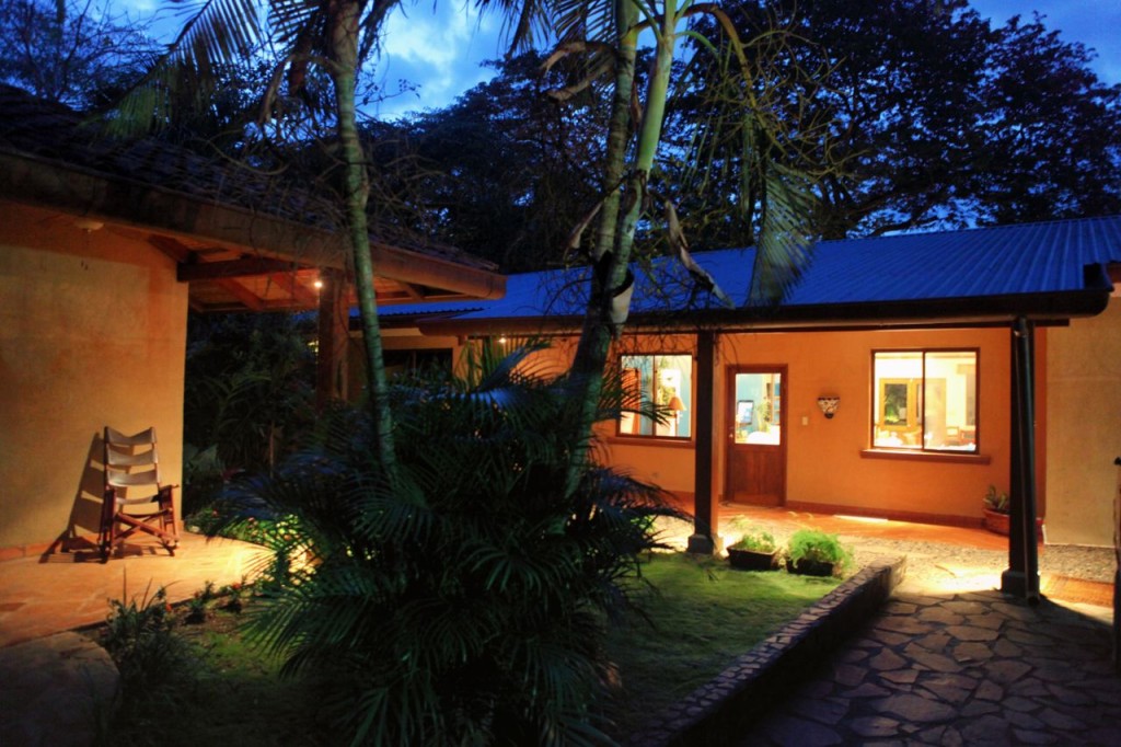 The courtyard path to the main house at dusk at Casa Colorado, a vacation rental home with a private pool in Tamarindo, Costa Rica