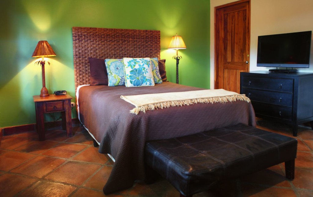 The casita queen bed and TV at Casa Colorado, a vacation rental home with a private pool in Tamarindo, Costa Rica