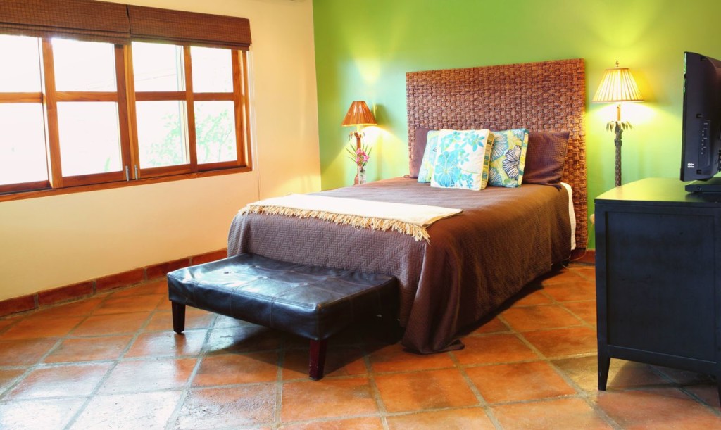 The queen bed in the casita at Casa Colorado, a vacation rental home with a private pool in Tamarindo, Costa Rica